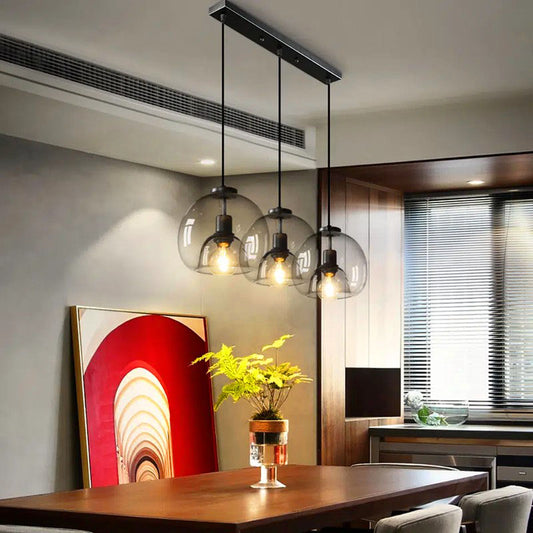 Jusole Lights - Glimmer - three-head pendant light in circular cluster or linear bar style, with gray, amber, or clear glass shades and warm or cool E27 LED illumination.