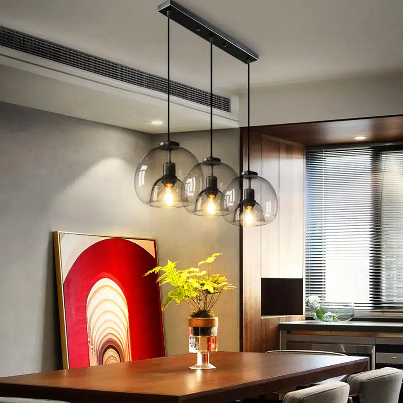 Jusole Lights - Glimmer - three-head pendant light in circular cluster or linear bar style, with gray, amber, or clear glass shades and warm or cool E27 LED illumination.