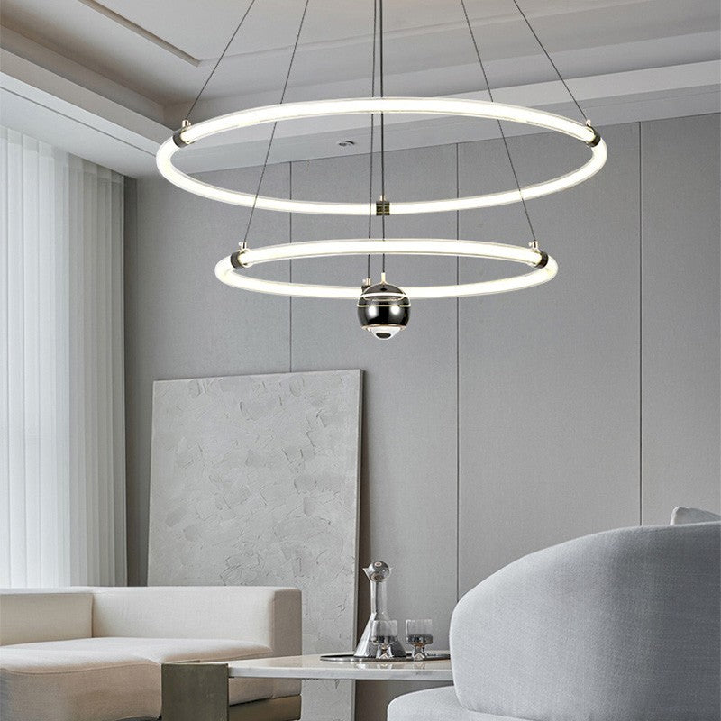 Orbita modern pendant light with acrylic rings, stepless dimming, 3 color temperatures, and 150cm adjustable suspension, ideal for living rooms, dining areas, and creative spaces.