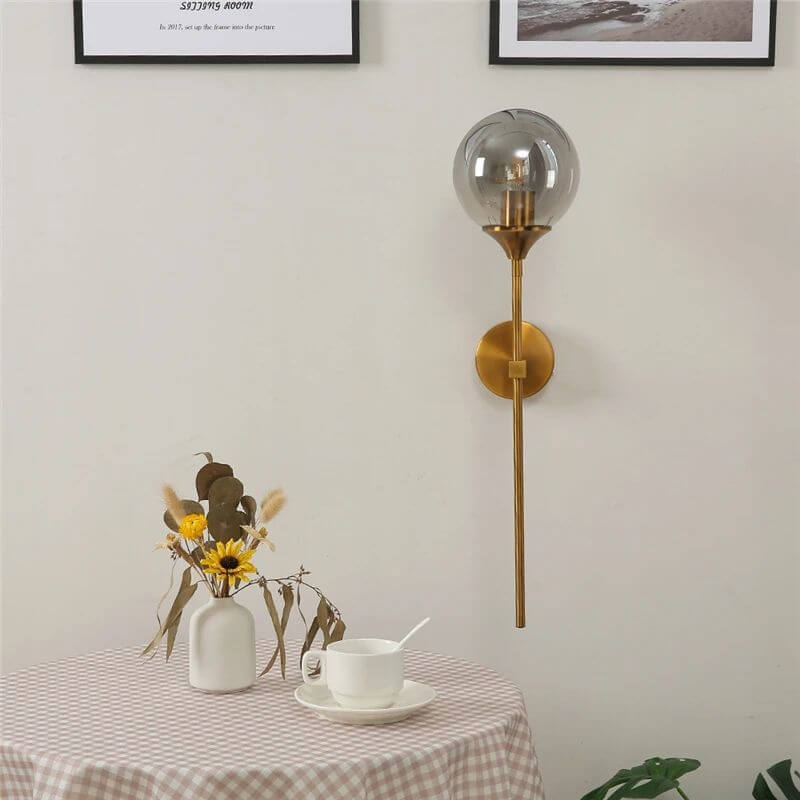Jusole Lights - Torch - Nordic modern LED wall lamp with brass finish and glass globe. Available in smoky gray, transparent, and amber. E14 socket, warm glow for elegant interiors.